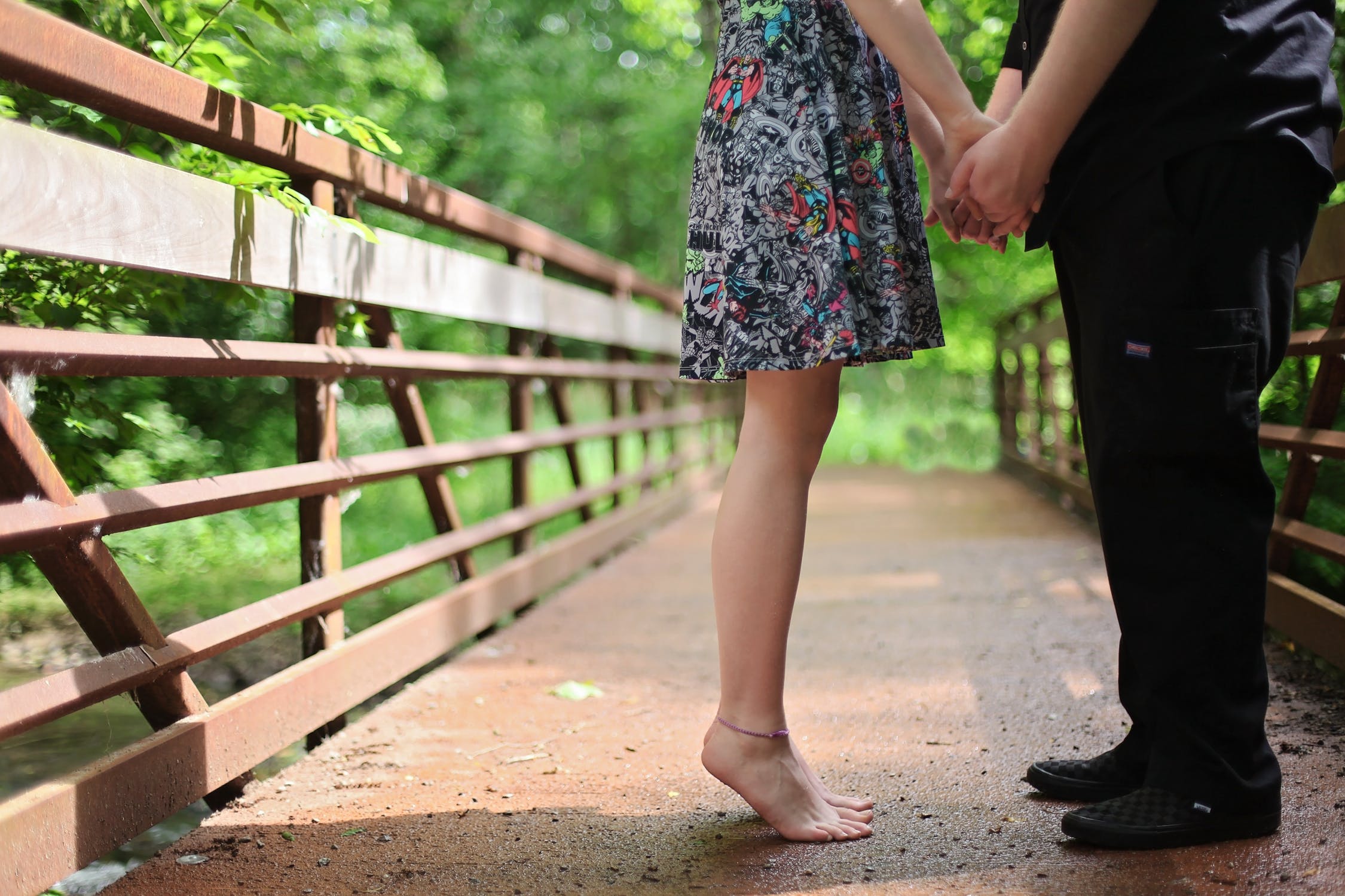 Couple kissing on a bridge